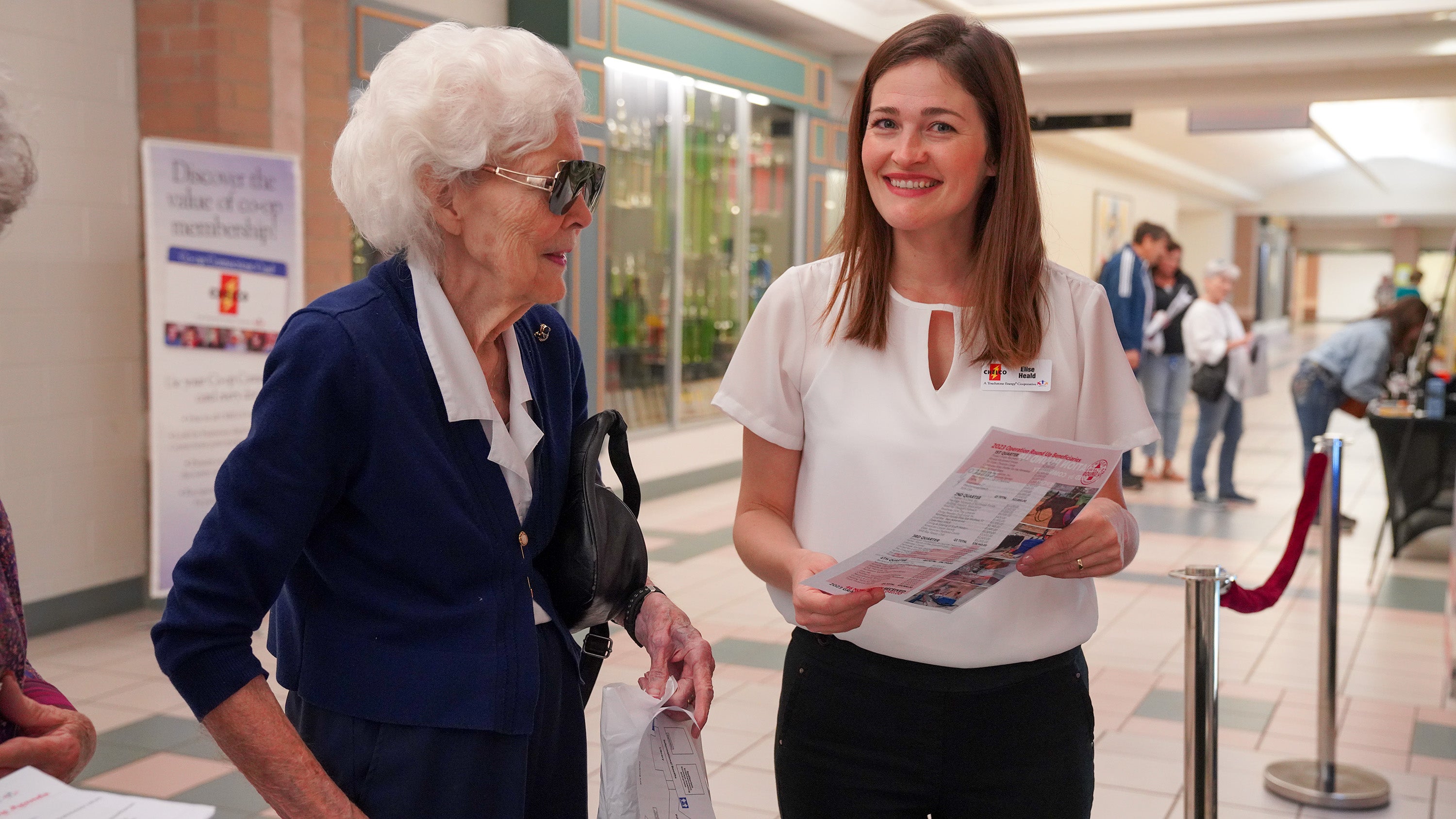 Member Service Representative Elise Heald talks with a CHELCO member before the Business Meeting
