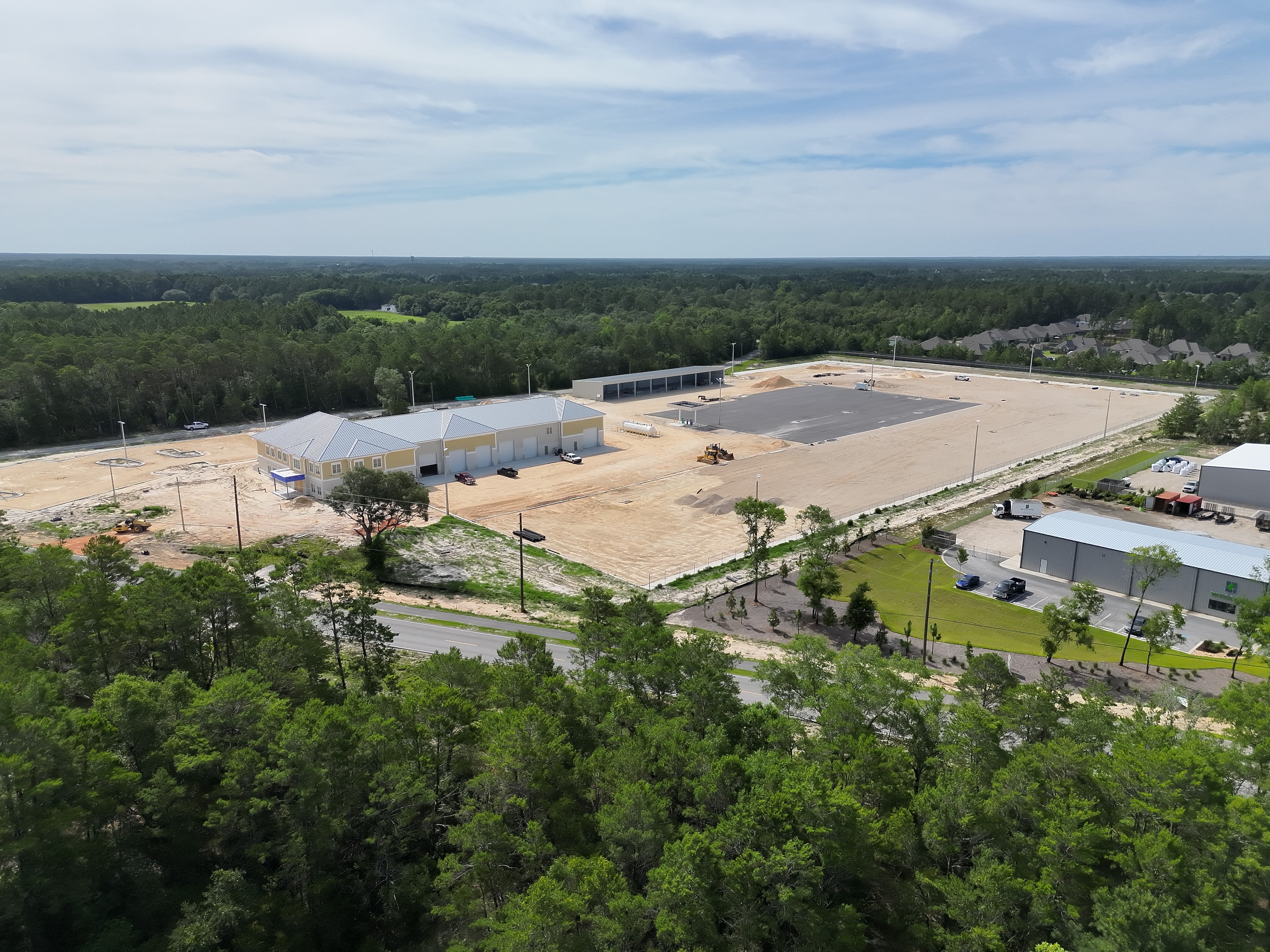 Situated on a 14.4‑acre parcel, the campus includes a 28,700‑square‑foot main building, a 10,000‑square‑foot storage facility, and approximately eight acres of improved surface for equipment laydown—critical for staging transformers, poles, and other materials needed to support reliable service.